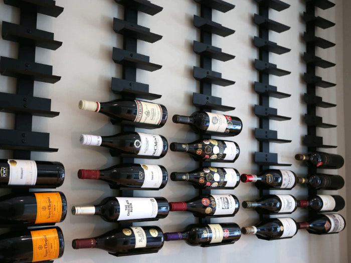 Wine bottles arranged on a wall-mounted wine rack.